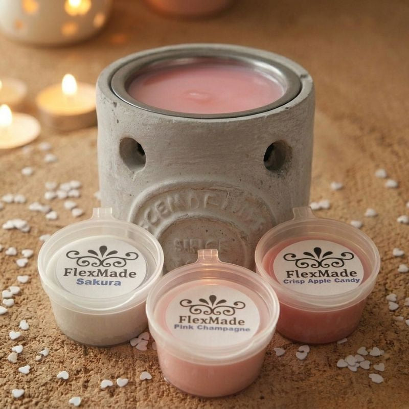 Betonlook brander met roze waxmelt in het schaaltje en drie bakjes waxmelts ervoor